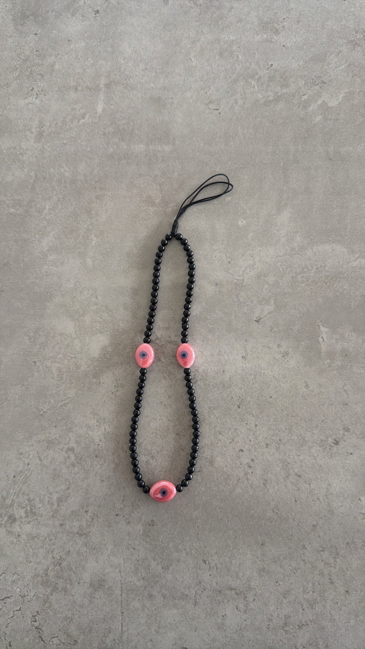 black with pink oval eyes short phonestrap