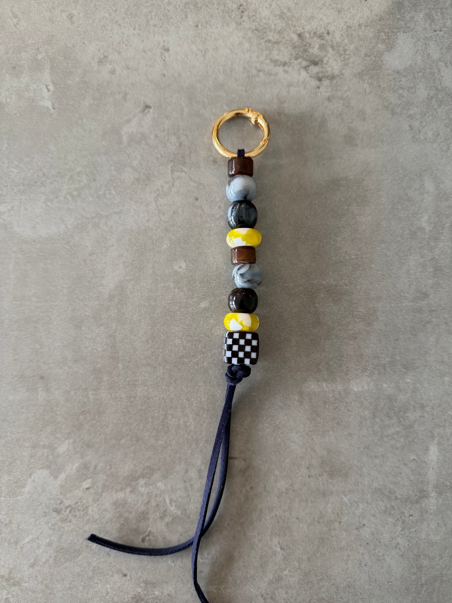 bag/key charm mixed - brown, greys, yellow and pattern.