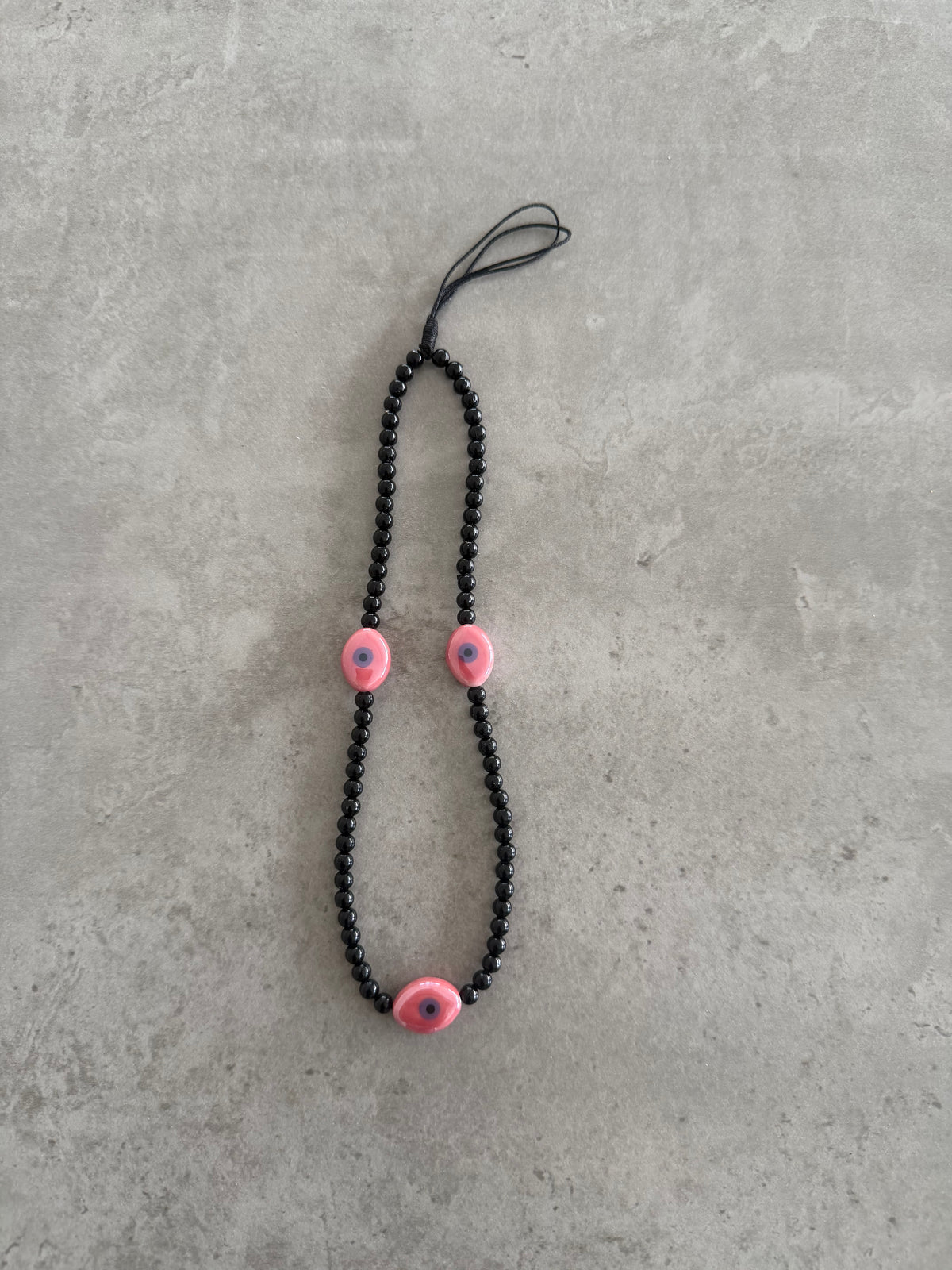 black with pink oval eyes short phonestrap