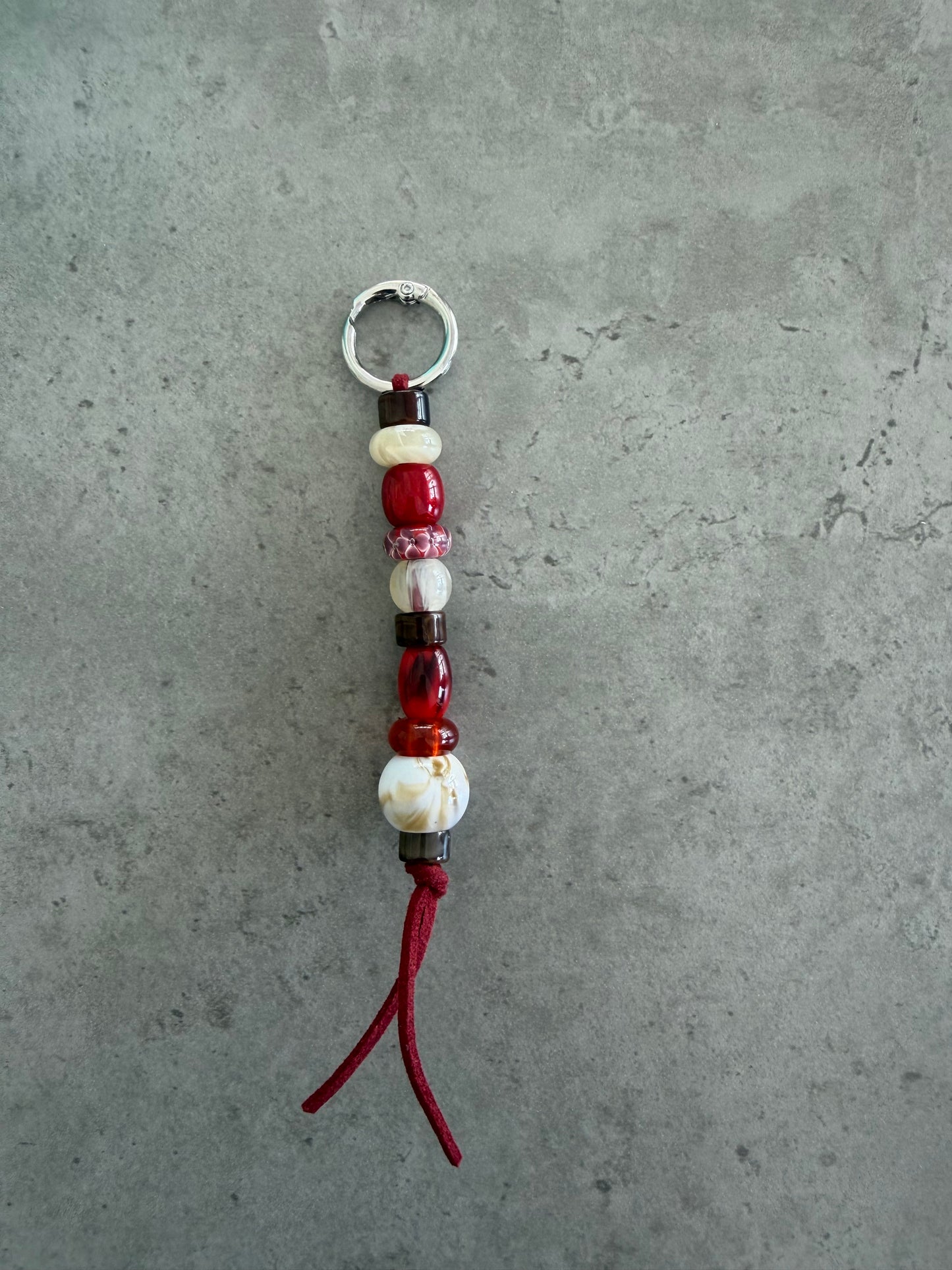 bag/key charm - reds creams brown